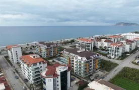1+1 Gemeubileerd Appartement te koop in een aan zee in Kestel Alanya